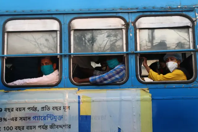 People wearing protective face masks travel in a passenger bus amidst the spread of the coronavirus disease (COVID-19) in Kolkata