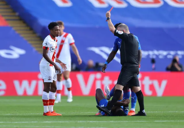 Southampton"s Kyle Walker-Peters is shown a red card by referee Jon Moss for a challenge on Crystal Palace"s Tyrick Mitchell