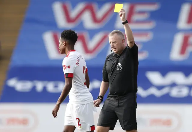 Jon Moss downgrades a red card shown to Kyle Walker-Peters to a yellow card