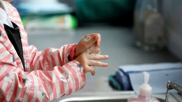 Child washing hands in school