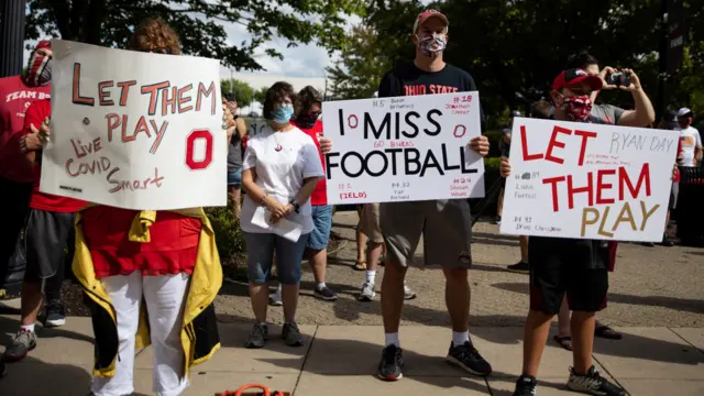 Fans attend a protest, staged by parents of Ohio State football players, against the cancelation of the Big Ten Conference's football season due to coronavirus concerns