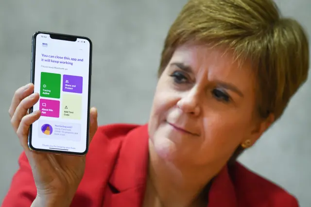 Nicola Sturgeon with the Protect Scotland app on her phone