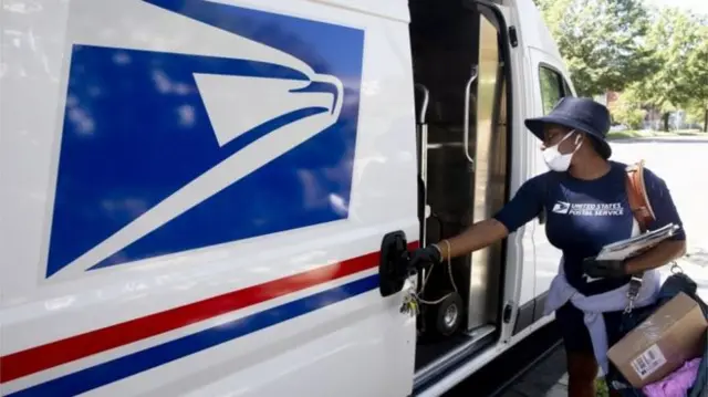 A postal worker wearing a mask