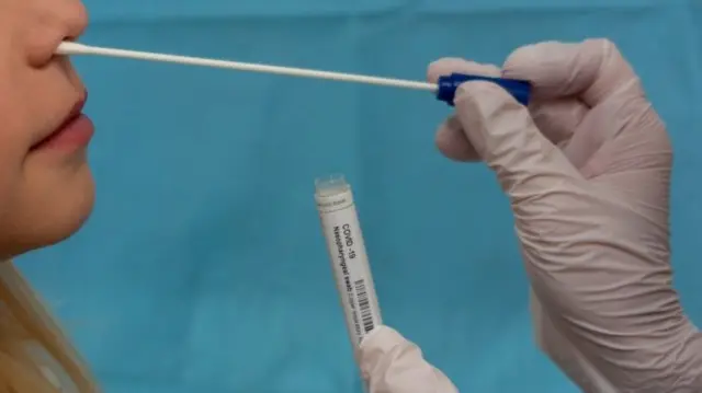 A person receiving a coronavirus swab test