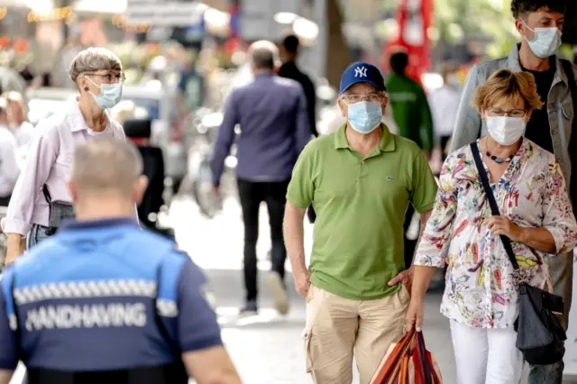Pedestrians wearing face masks in Rotterdam, 23 August