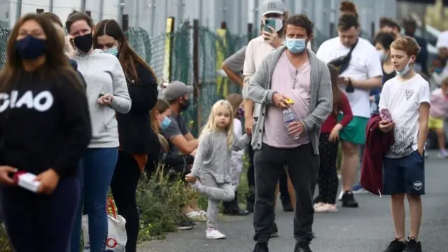 People queuing at a test centre in England