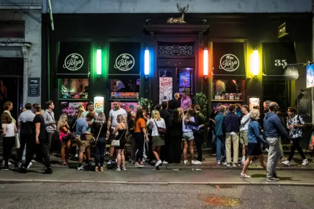 People gather outside a bar in Copenhagen