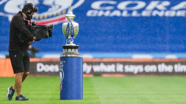 Challenge Cup on plinth with cameraman filming