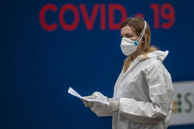 A woman wearing PPE stands at a testing facilty in the Czech Republic