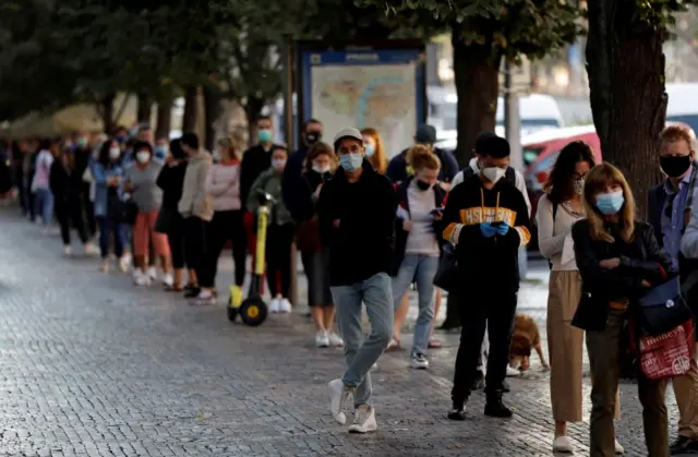 People wait for testing in Prague