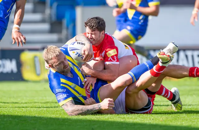 Warrington's Blake Austin is tackled by St Helens' Lachlan Coote