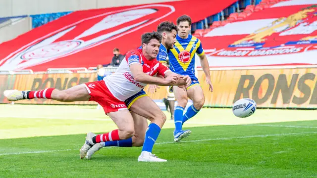 St Helens' Lachlan Coote is able to push the ball into touch before Warrington's Joe Philbin can touch it down for a try.