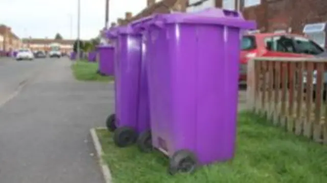 Purple wheelie bins