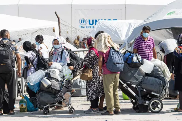 Migrants queue to enter Kara Tepe camp in Lesbos on 18 September 2020