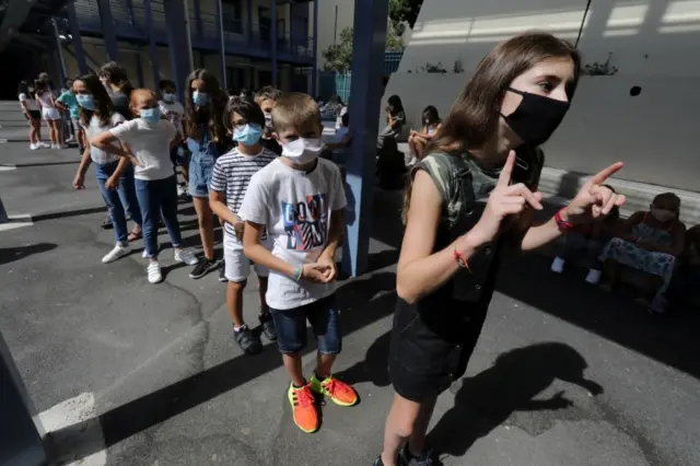 Children, wearing masks, line up at a school in Nice on 1 September 2020