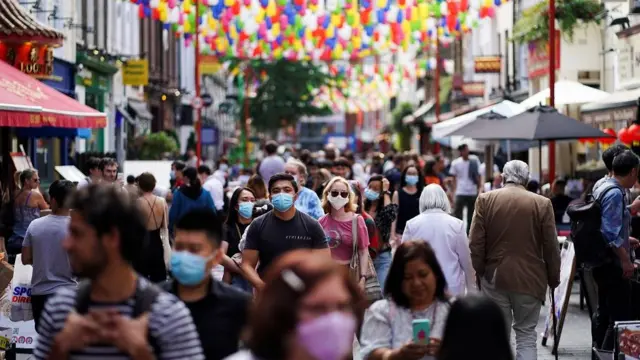 People walk through the Chinatown area, amid the coronavirus disease (COVID-19) outbreak, in London, Britain