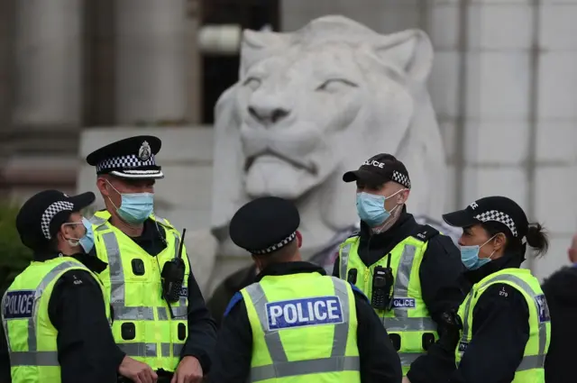 Police officers wearing masks