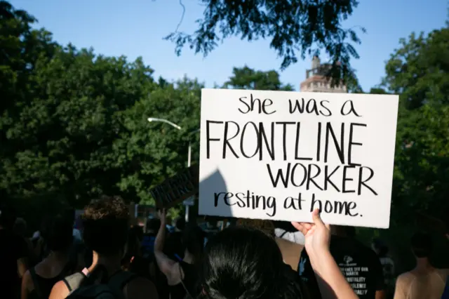 "She was a frontline worker" reads one sign