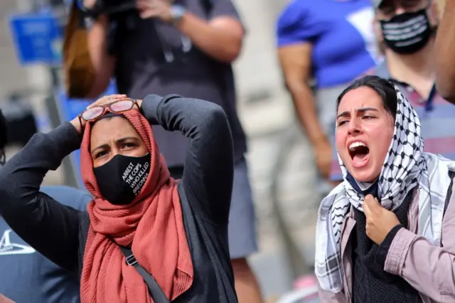 Protesters react to the lack of murder charges against the three officers involved in Ms Taylor's death