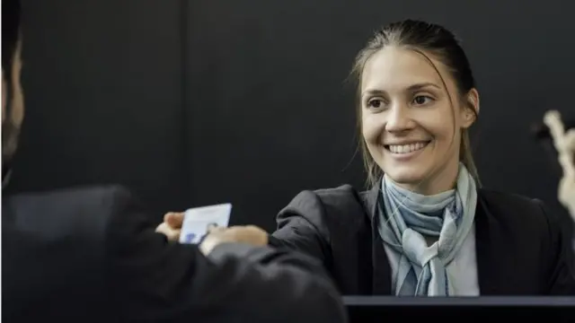 A woman showing her ID