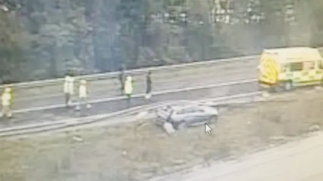 Car stuck under crash barrier