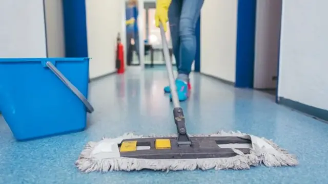 Someone cleaning a floor