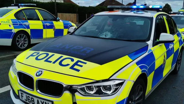 Police car with damaged windscreen