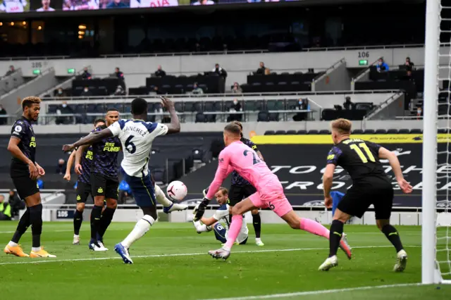 Karl Darlow of Newcastle United saves a shot from Davinson Sanchez of Tottenham Hotspur