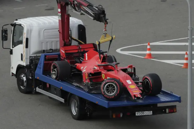 Sebastian Vettel's Ferrari is towed away