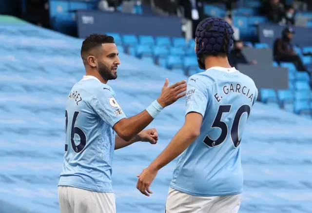 Riyad Mahrez and Eric Garcia celebrate