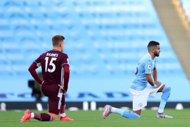 Riyad Mahrez and Harvey Barnes take the knee before Manchester City v Leicester