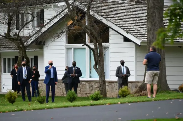 Democratic presidential nominee and former Vice-President Joe Biden greets a neighbor (R) from the private home he is staying in while in Cleveland, Ohio on September 29, 2020, ahead of the first Presidential debate