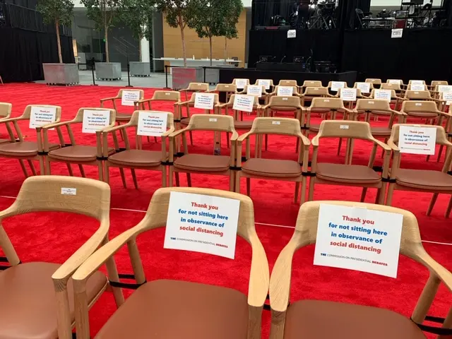 Chairs with signs instructing people to follow social distancing rules