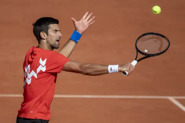 Novak Djokovic hits a backhand