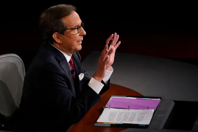 Moderator Chris Wallace of Fox News gestures toward President Donald Trump and former Vice President and Democratic presidential nominee Joe Biden at the Health Education Campus of Case Western Reserve University on September 29, 2020 in Cleveland, Ohio