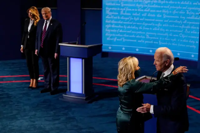 First lady Melania Trump stands with President Donald Trump as he looks at Democratic presidential candidate former Vice President Joe Biden as he is hugged by his wife Jill Biden during the first presidential debate at the Health Education Campus of Case Western Reserve University on September 29, 2020 in Cleveland, Ohio.