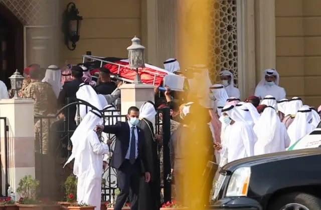 People at funeral wearing masks