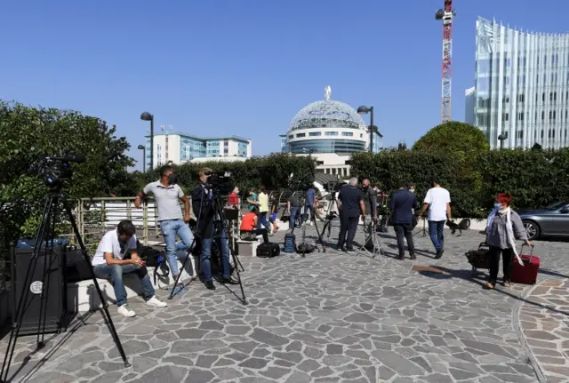 Media gather outside the San Raffaele hospital