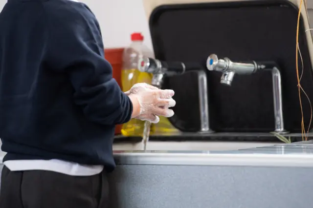 School child washing hands