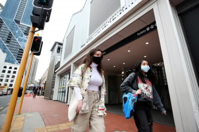 Women in face masks walk through the streets in Auckland on 31 August 2020