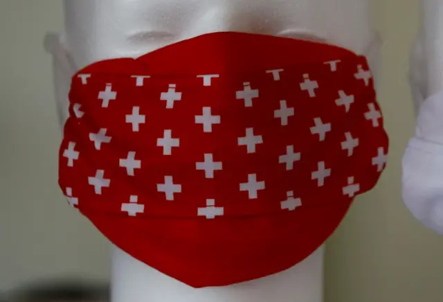 A face mask with the design of the Swiss cross