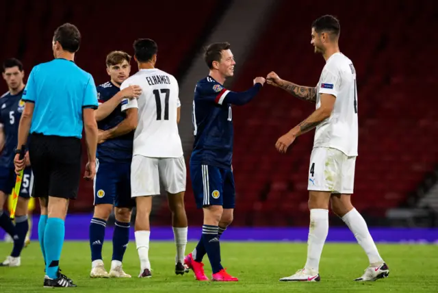 Celtic teammates James Forrest and Hatem Elhamed, plus Callum McGregor and Nir Bitton embrace at full-time