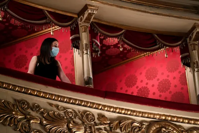 A visitor wearing a face mask looks on as Italy's La Scala opera house reopens to the public for the first time since the coronavirus disease outbreak, with new social distancing and hygiene rules, in Milan, Italy, in June 2020