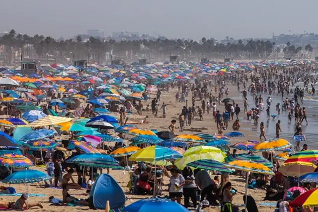 People gather on the beach on the second day of the Labor Day weekend amid a heatwave in Santa Monica, Caifornia on September 6, 2020.