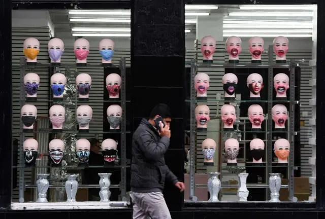 Man in front of Glasgow mask shop