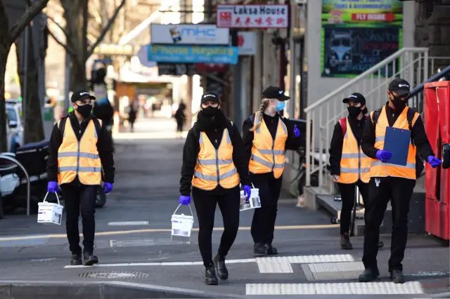 Cleaners walk along Elizabeth Street in Melbourne, Australia, 03 Septemberr 2020.