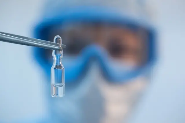 A Russian scientist holds a vial with a vaccine against Covid-19