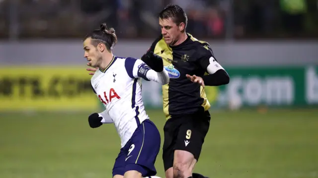 Gareth Bale of Tottenham is challenged by Niall Cummins of Marine