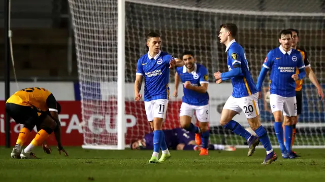 Brighton's Solly March celebrates with teammate Leondro Trossard