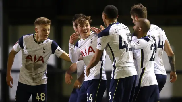 Alfie Devine celebrates with his Tottenham teammates after scoring against Marine